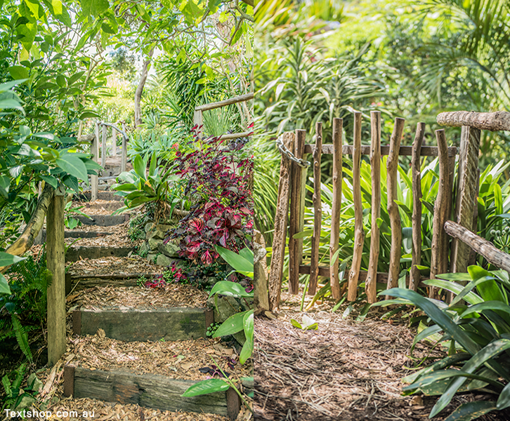 Two photos featuring Zig zag pathways with railway sleeper steps and bush rail balustrades.