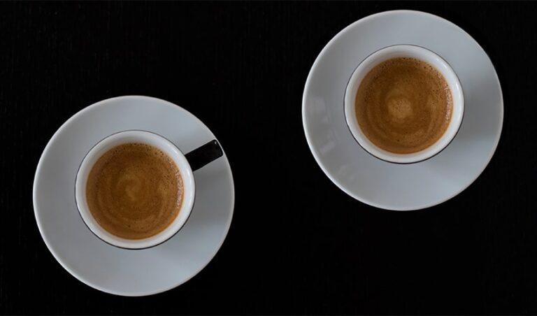 Overhead shot of two cups of coffee used as a model for the grammar question 'Which is that pronoun?'